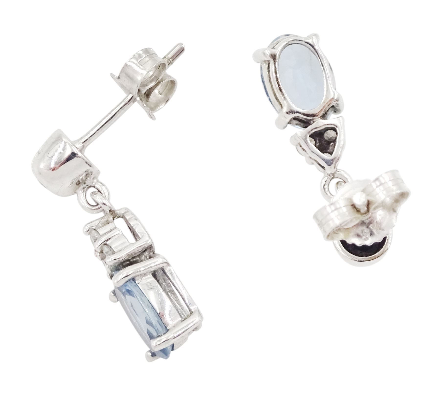 Pair of 9ct white gold oval cut aquamarine and round brilliant cut diamond stud earrings, hallmarked