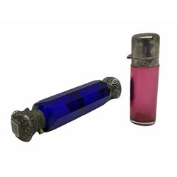 Late Victorian silver mounted ruby glass cylindrical scent bottle, with interior glass stopper, Birmingham 1900, makers mark worn, H8cm, together with a Victorian double ended cut blue glass perfume bottle mounted with white metal screw and flip caps decorated with foliate repousse detailing, H13.5cm
