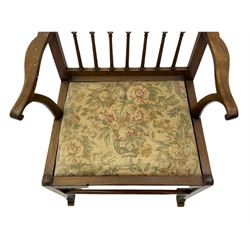 Late 18th century walnut 'Drunkard's' chair, the shaped cresting rail over spindle back, wide set seat with upholstered drop in cushion, shaped arms with scroll carved terminals, sledge supports with bracket feet joined by plain stretchers 