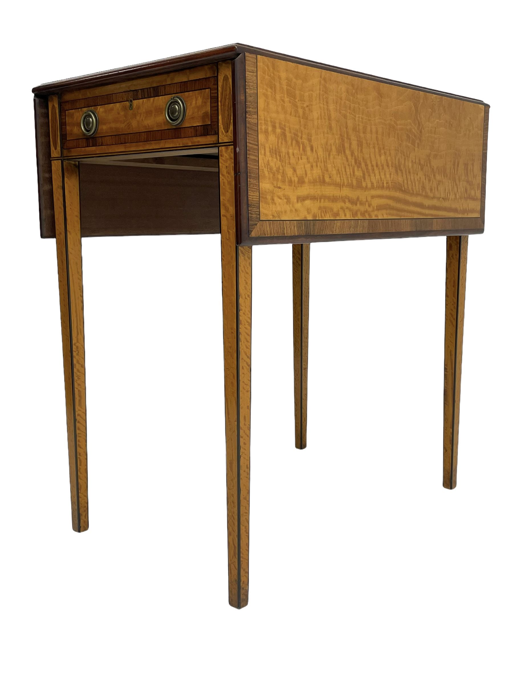 Mid-to-late 20th century Sheraton style satinwood Pembroke table, the drop leaf top with segmented veneers and central oval panel with ebony stringing, crossbanded in rosewood and with edge moulding, single short drawer to one end and faux drawer to other, square tapering supports