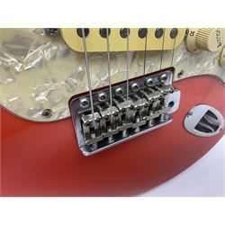 Japanese Squier Fender 'Hank Marvin' Stratocaster electric guitar, c1992, in Fiesta red with tremolo arm and facsimile signature decal; serial no.L037281, L98cm; in hard carrying case.