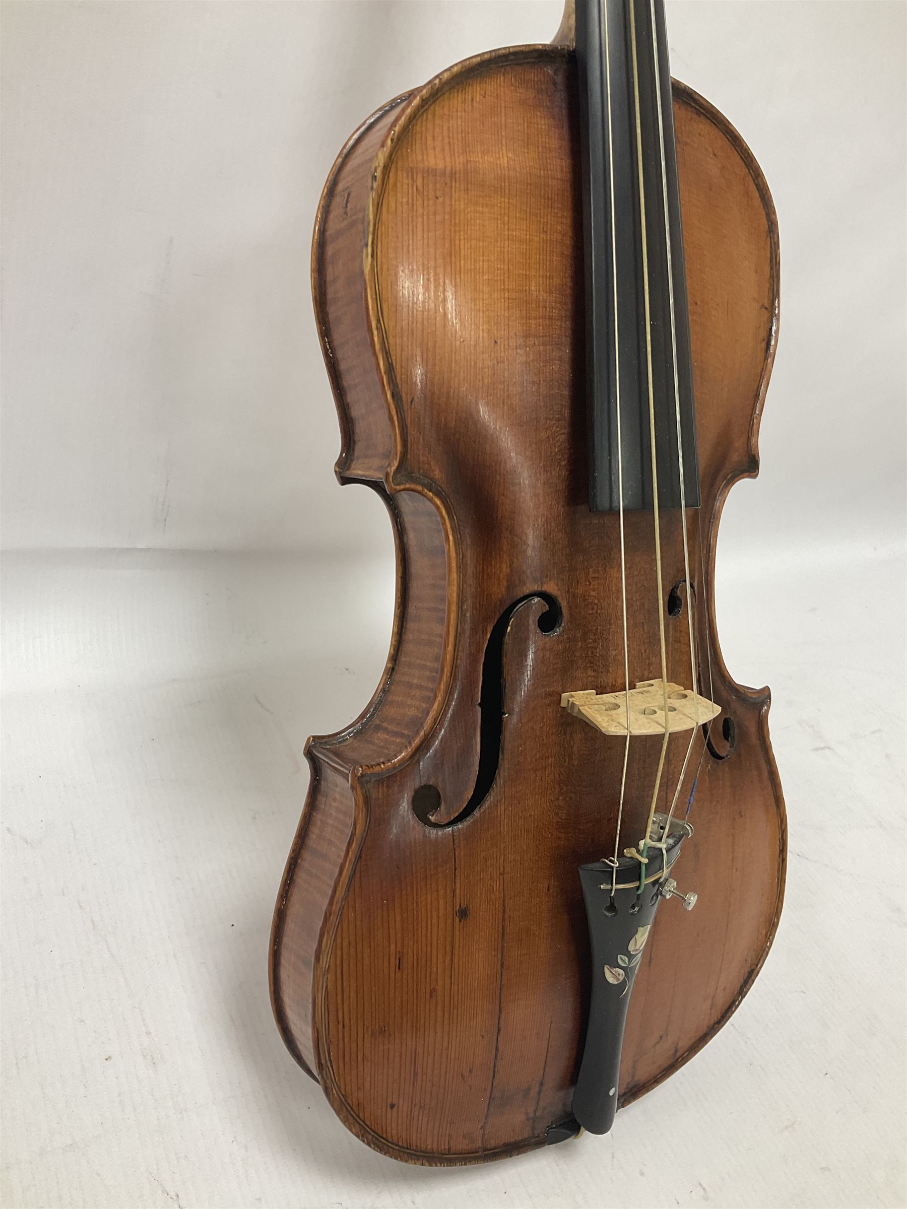 19th century full sized violin in a later hard case, decorative mother of pearl inlay to the tail piece Overall length 60cm No bow