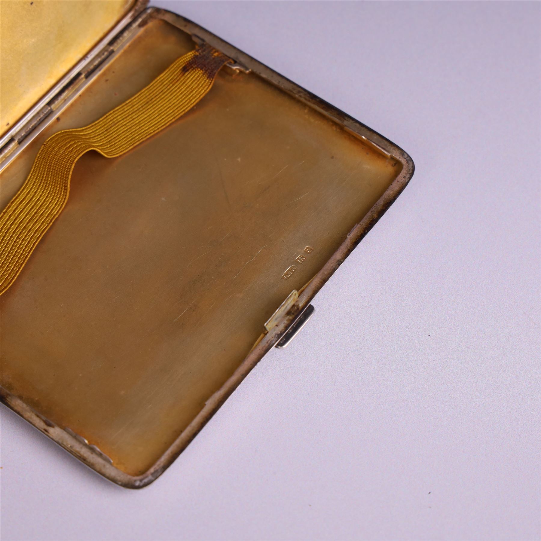 1930s silver cigarette case, of rectangular form with rounded corners, with engine turned decoration throughout, with personal engraving to interior, hallmarked Padgett & Braham Ltd, London 1931, L 11cm 