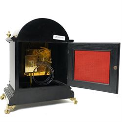 Winterhalder & Hoffmeier-8-day early 20th century mantel clock with an ebonised finish, break arch pediment and two matching brass finials, conforming glazed door with a cast brass bezel flanked by reeded quarter pilasters, on a moulded plinth with scroll feet, brass dial with cast spandrels and strike/silent and pendulum regulation dials to the arch, matted dial centre with a silvered chapter, Roman numerals  and gothic steel hands, dial pinned to a quarter striking movement sounding the quarters on two gongs and hours on one. With Pendulum.
