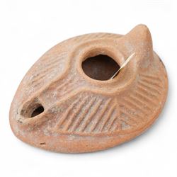 A group of four Byzantine terracotta oil lamps - Eastern Mediterranean, c.5th-7th century AD, comprising a group of mould-made slipper-form oil lamps, each with a rounded body, large central filling hole, and a short to elongated nozzle; including one with fine radiating linear decoration, and another preserving ancient use with traces of oil and wick residue within the burnished interior; together with a Crusader-period terracotta oil lamp (c.12th-13th century AD) of angular form with recessed panel decoration and a pierced handle moulded as a stylised animal head
Provenance: By the vendor’s repute, acquired/collected in the Middle East (Dead Sea area/Syria) in the 1960s