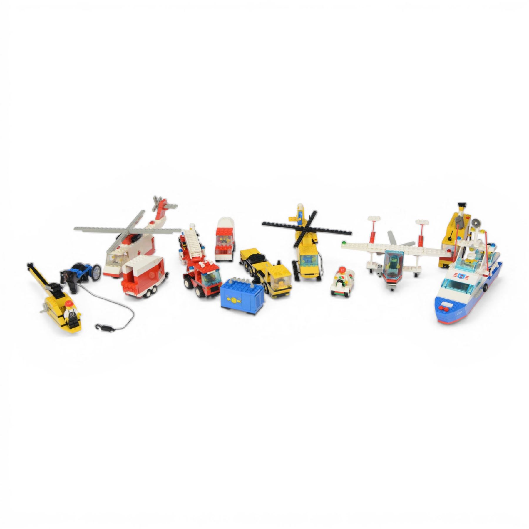 Eight vintage Lego Classic Town vehicles, comprising no. 6853 Coastal Cutter, no. 6359 Horse Trailer, no. 6693 Recycle Truck, no. 6361 Mobile Crane, no. 6340 Hook and Ladder, no. 6691 Red Cross Helicopter, no. 6341 Gas 'n' Go Flyer and no. 6697 Rescue Helicopter, all built with minifigures