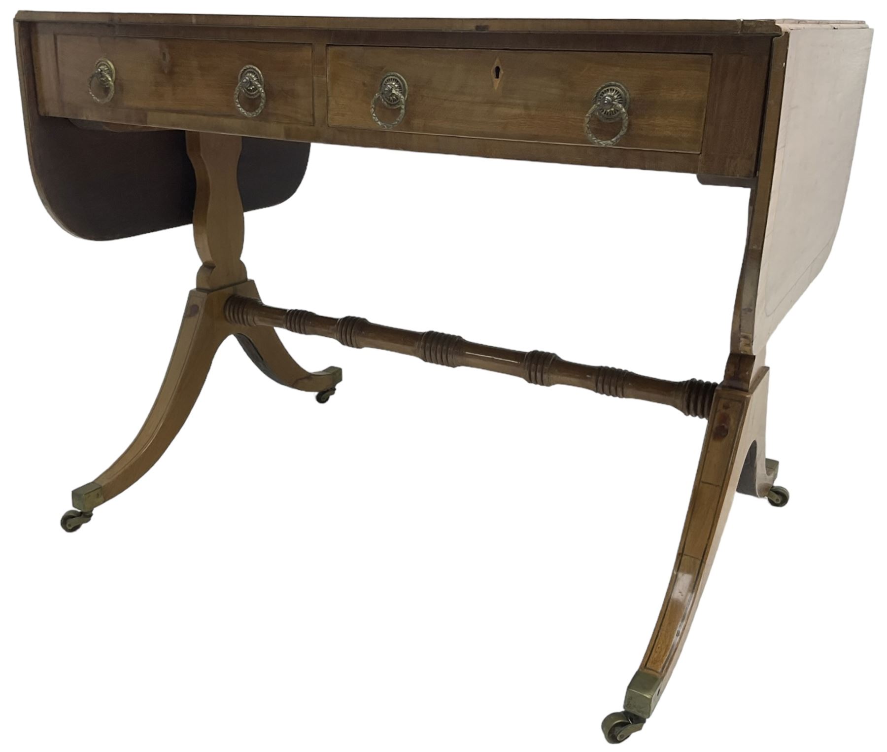 Regency mahogany sofa table, rectangular crossbanded top with twin drop-leaf ends, fitted with single drawer and one faux drawer, raised on shaped end supports united by ring turned stretcher