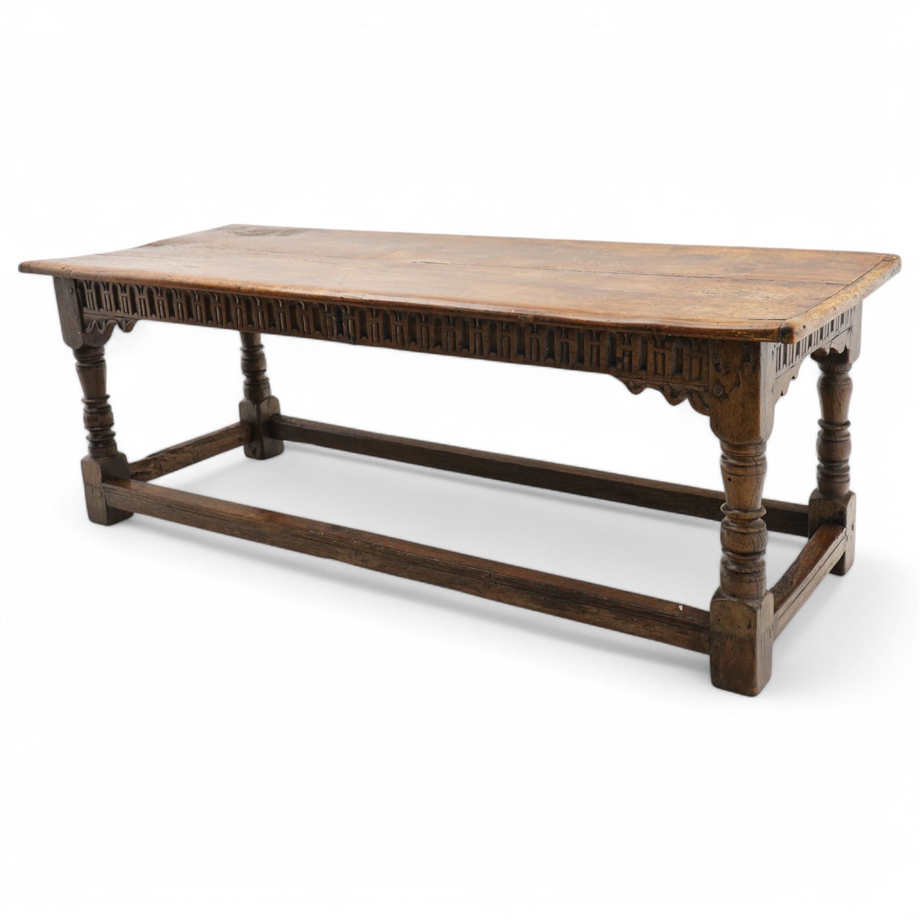 Charles I rectangular joined oak and elm refectory table, the frieze carved with repeated arch motifs, pearwood top above four turned supports united by horizontal stretcher, first half 17th century
Provenance: Purchased from Thorpe & Foster of Dorking in 1971

