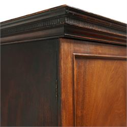 George III mahogany linen press, dentil moulded cornice over a pair of panelled doors enclosing a later fitted interior, lower section with two short over one long cockbeaded drawer, brass swan neck handles, shaped bracket feet