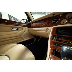 2001 Bentley Arnage Red Label Saloon

Registration: BU51 TGX
Engine: 6.75-litre turbocharged V8 petrol
Transmission: Automatic
Odometer reading: 39,942 miles
Colour: Black Sapphire metallic
Interior: Magnolia leather with burr walnut veneers
Previous owners: 3
V5C: Present
Service history: Good service records

An exceptional Bentley Arnage Red Label Saloon, finished in Black Sapphire metallic, a very dark blue, with a Magnolia leather interior, contrasting dark blue carpets and extensive burr walnut veneers. The car displays an odometer reading of approximately 39,942 miles.

The Arnage Red Label combined Bentley’s renowned 6.75-litre turbocharged V8 engine with automatic transmission, delivering effortless performance in a traditionally appointed luxury saloon. The model is distinguished by its imposing proportions, characteristic Bentley radiator grille and finely crafted interior.

Presented in excellent condition throughout, the bodywork and metallic paint finish appear particularly well preserved, complemented by clean brightwork and the correct Bentley alloy wheels. The engine bay is also notably well detailed.

The interior presents exceptionally well, retaining its Magnolia leather upholstery, polished burr walnut veneers, original factory instrumentation and switchgear. The leather displays only light creasing consistent with careful use.

The car has had three previous owners and is accompanied by good service records.

Features

• 6.75-litre turbocharged V8 petrol engine
• Automatic transmission
• Black Sapphire metallic paintwork
• Magnolia leather interior
• Contrasting dark blue carpets
• Burr walnut veneers
• Electrically adjustable front seats
• Air conditioning
• Factory instrumentation and switchgear
• Bentley alloy wheels
• Right-hand drive
• Odometer reading of approximately 39,942 miles
• Three previous owners
• Good service records
• V5C present

This vehicle forms part of the Estate of the Late John Sills and is offered for sale by the Executors, confirming a genuine reason for sale.
