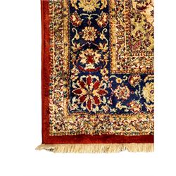 Persian design crimson ground rug, rectangular field with indigo medallion surrounded by trailing and interlaced branches, within wide borders decorated with repeating plant motifs