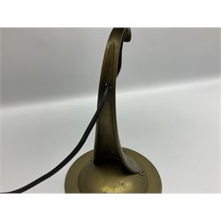 Arts & Crafts Jesson, Birkett & Co, brass table lamp or wall light, designed by Thomas Birkett, the tapering stem with adjustable ball pivot supporting a conical shade with tapering final with ball terminal, upon a circular domed base pierced for wall mounting, shade positioned upright overall H57cm

Often misattributed to Arthur Stansfield Dixon for Birmingham Guild of Handicraft, this particular lamp was designed by Thomas Birkett.
In the late 1890's Birkett worked as a metalwork at the Birmingham Guild, before later joining the Faulkner Bronze Company which went on to become Jesson, Birkett & Co in 1904. The lamp features in lighting catalogues from the firm under the model no E490.

