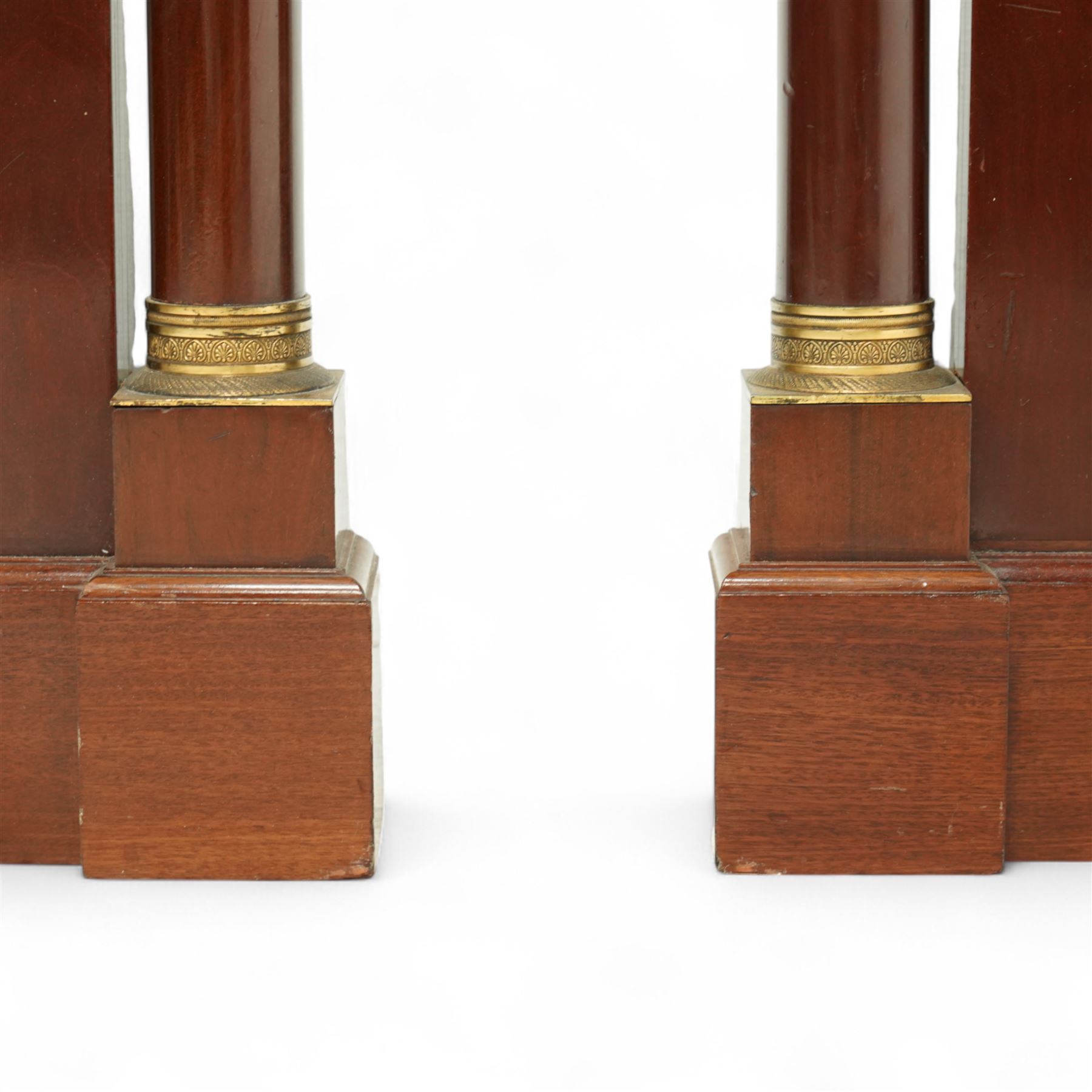 Rare pair of French Second-Empire neoclassical style mahogany mirrors with ormolu mounts, architectural pediment with central ormolu patera above flame mahogany frieze with honeysuckle flower and caryatid mounts, the frame with ormolu beading and bevelled mirror plates, flanked by turned columns with ormolu mounts above a reverse breakfront base, circa 1870