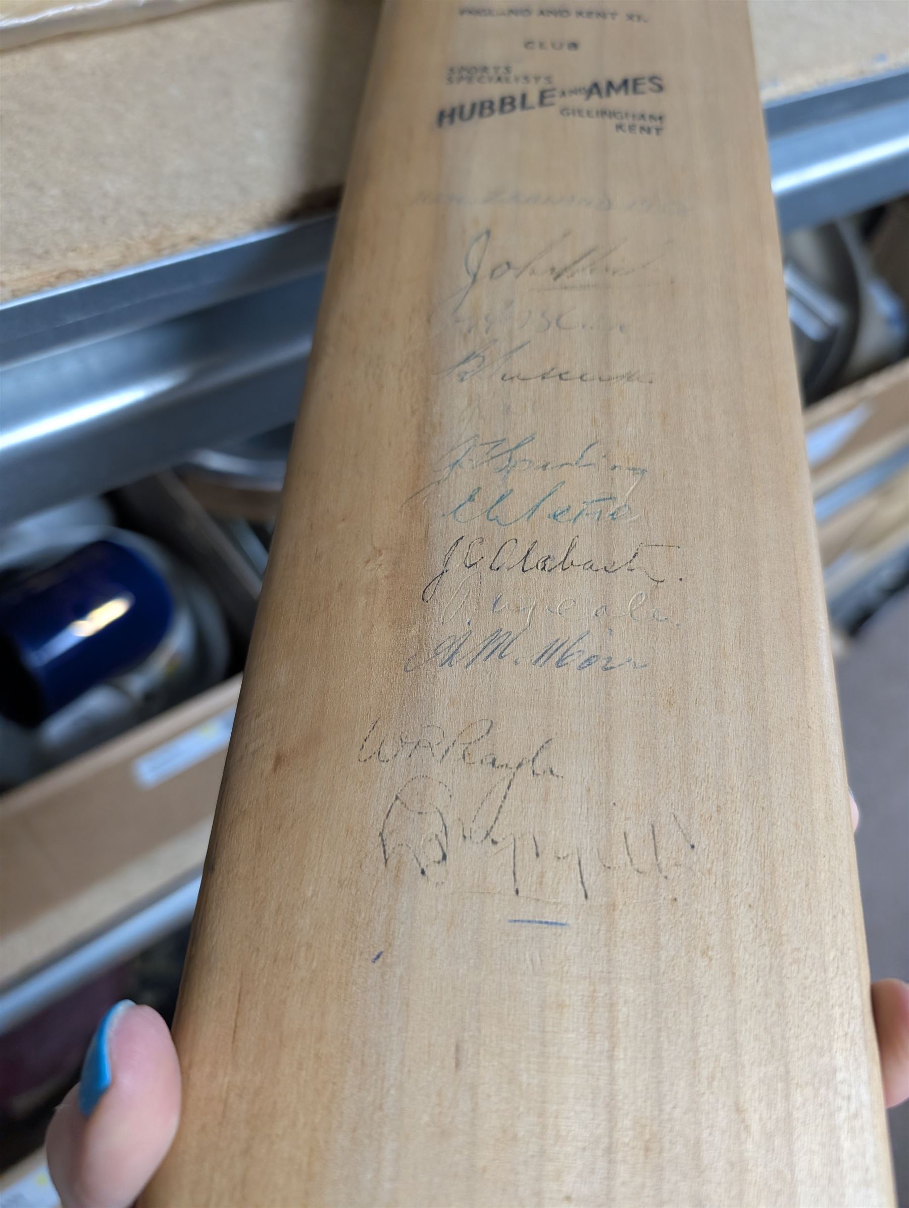 Two signed cricket bats, with signatures including Colin Cowdrey