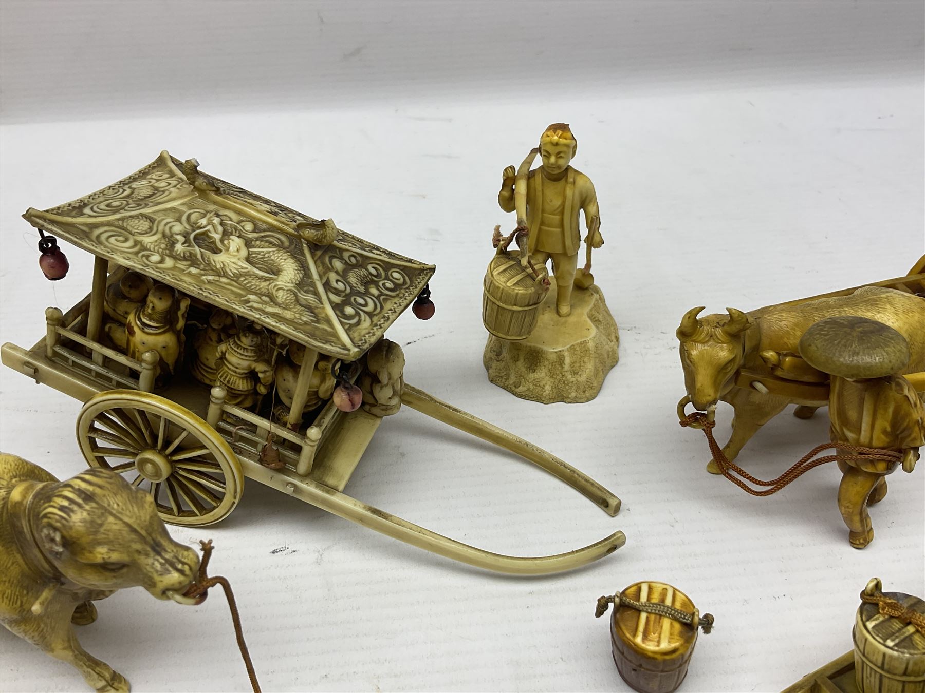 Collection of Japanese celluloid figures, including Rickshaw groups, fishing scene, oxen etc 