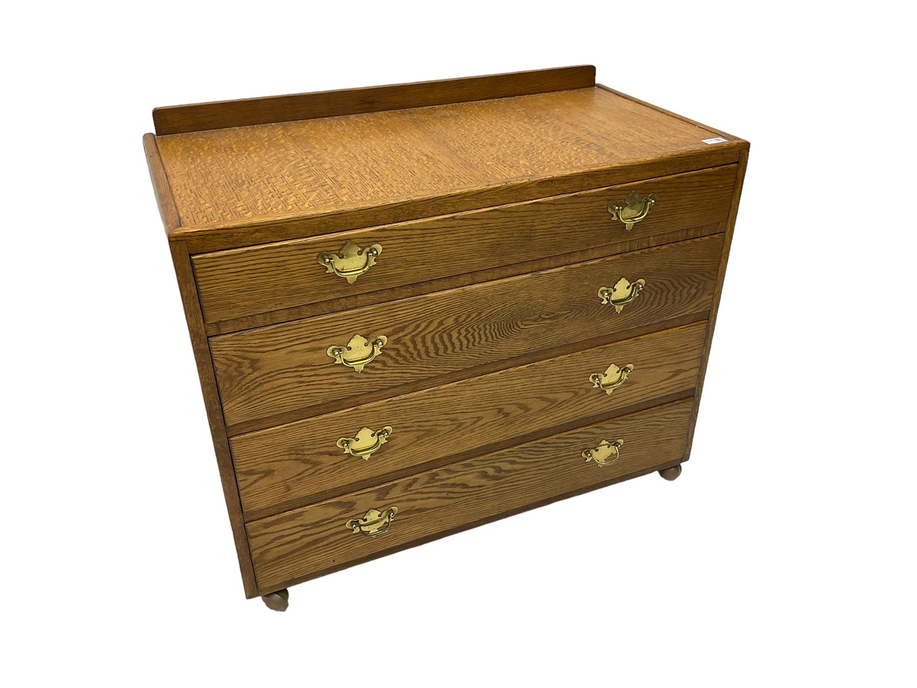 Mid-20th century oak chest, raised back, fitted with four graduating drawers, on castors