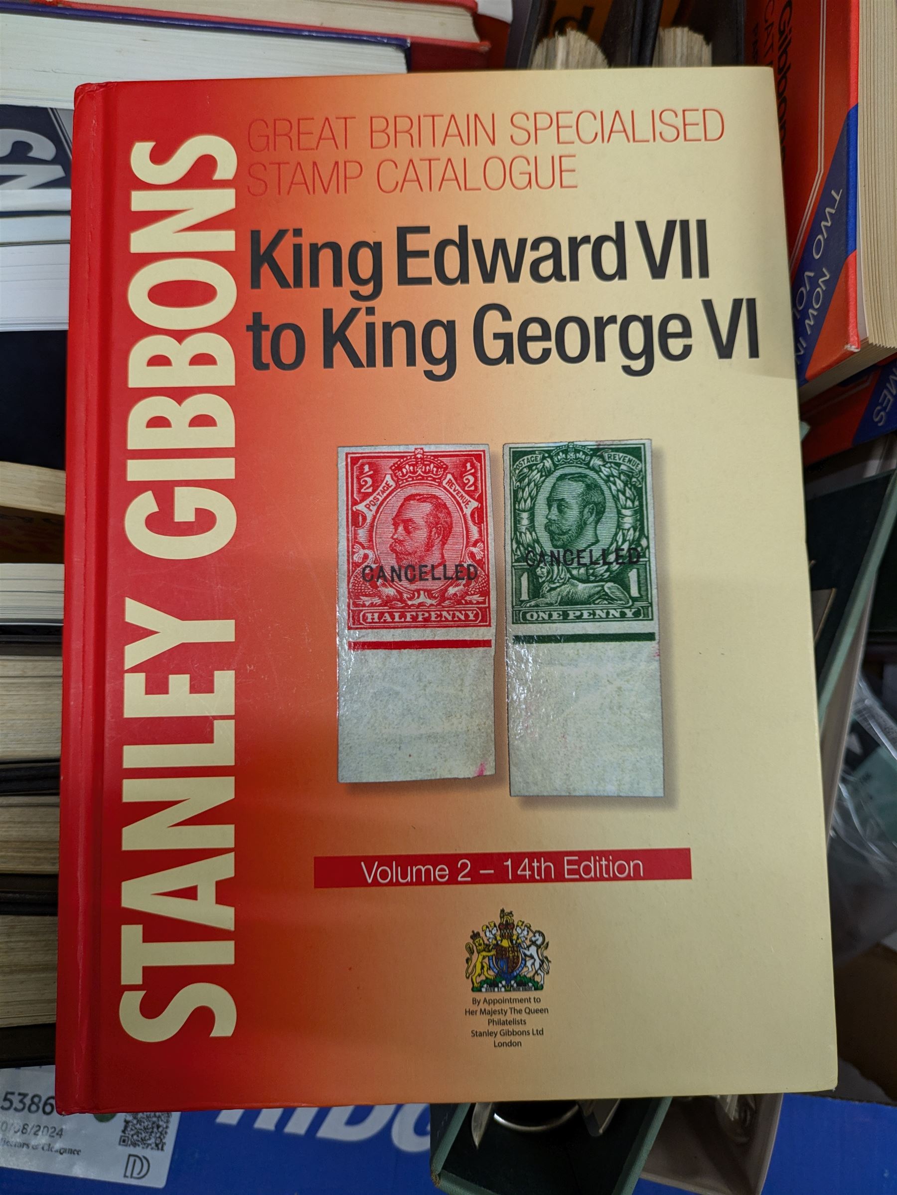 Stamp and coin reference materials, including Stanley Gibbons 2023 'Great Britain Concise' stamp catalogue, various editions of 'The Postal Stationary Society', empty stamp albums etc, in two boxes
