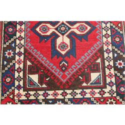 Two Persian rugs, Persian Hamadan hand-knotted rug, ivory ground centred by a terracotta medallion, surrounded by scrolling floral and foliate motifs, dark navy floral border with narrow guard stripes, fringed ends, H 176cm, W 75cm, Persian tribal hand-knotted rug, madder red ground decorated with three large geometric medallions, surrounded by angular motifs, enclosed by multiple geometric borders in dark navy, ivory and red, fringed ends, H 150cm, W 91cm