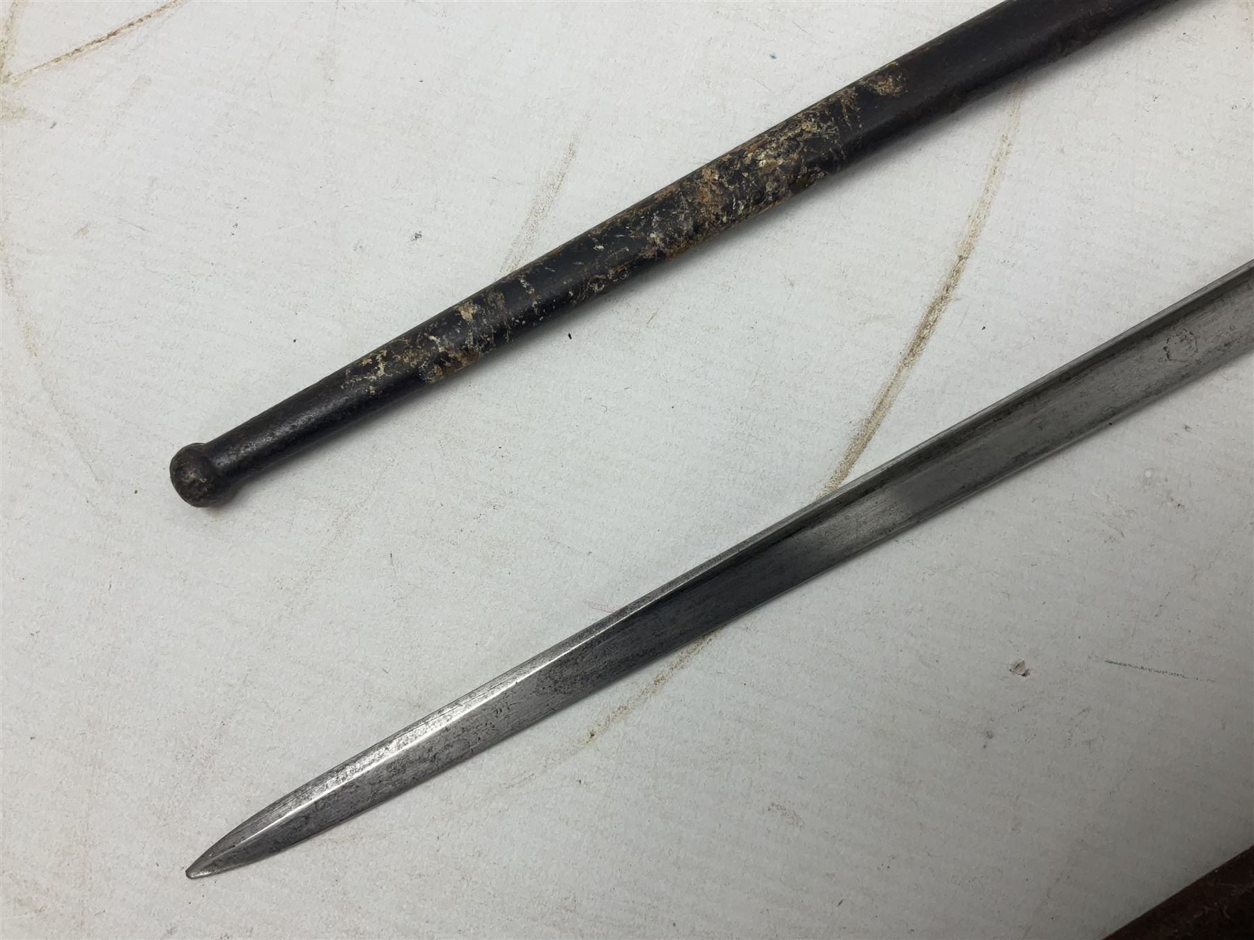 French Model 1874 Epee bayonet marked Oulle 1876 in associated scabbard; Model 1866 sabre bayonet in cut-down sword scabbard; and Model 1842/59 sabre bayonet in relic condition (3)