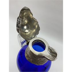 20th century silver plate mounted blue glass claret jug, modelled in the form of a parrot, the blue glass body with silver plated parrots head with inset glass eyes, upon two silver plated talon feet, H29cm