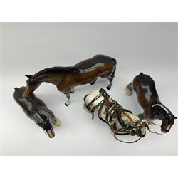 A Beswick large model of a Racehorse, model no 1564, together with three Beswick Shire Horses, to include a pair, each with printed marks beneath. (4). 