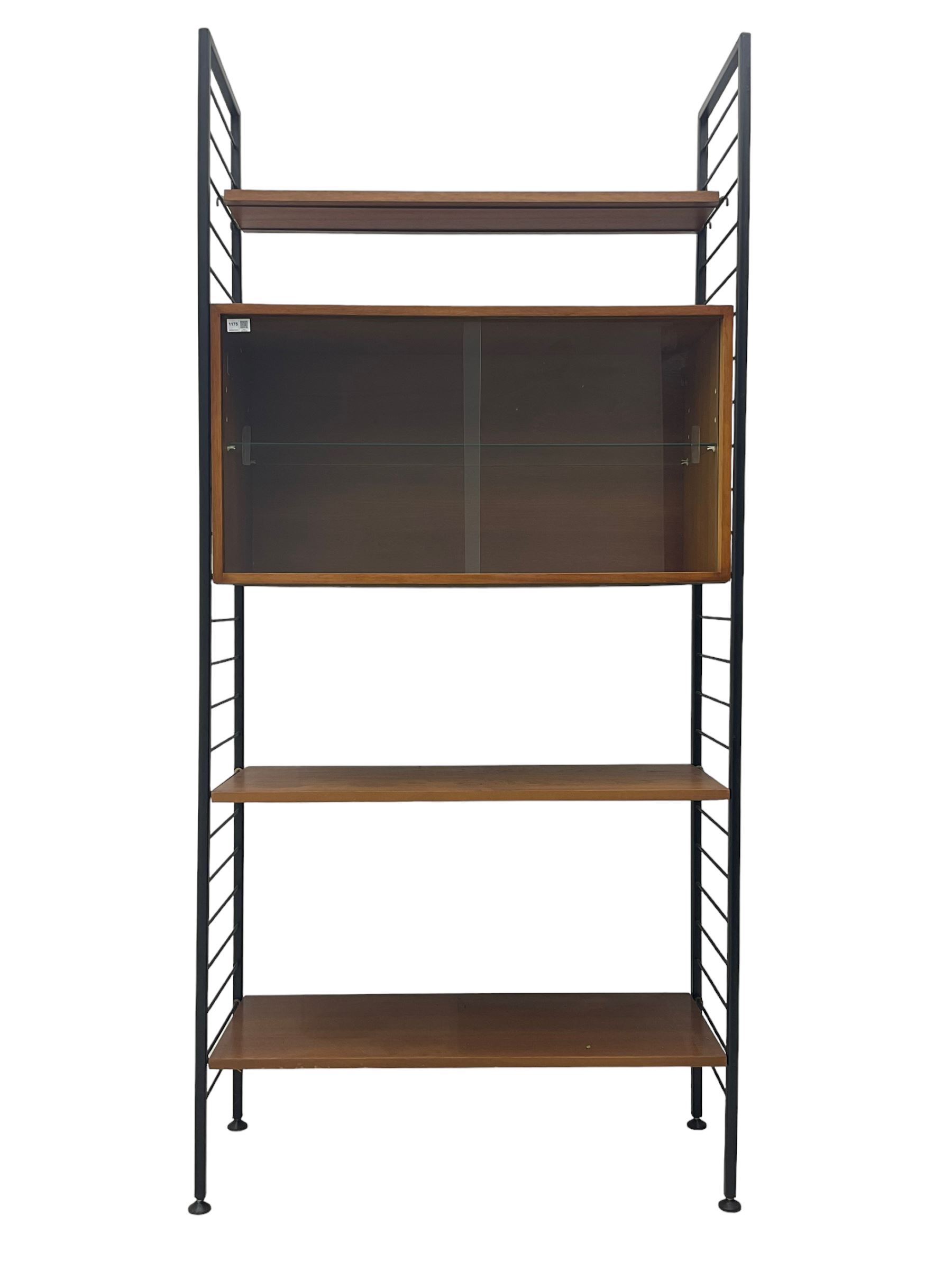 Staples Ladderax - mid-20th century teak and metal framed modular wall unit, fitted with central cupboard, the sliding glazed doors enclosing single shelf, flanked by three adjustable shelves 