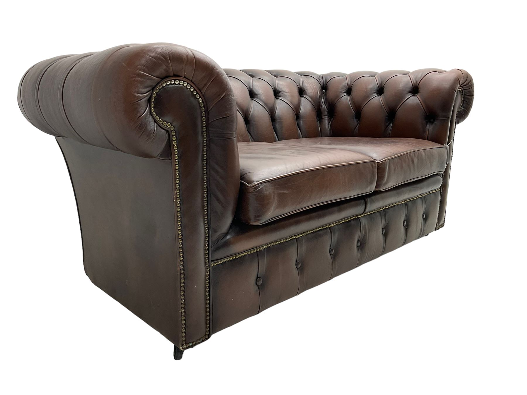 Chesterfield two seat sofa, upholstered in brown buttoned leather