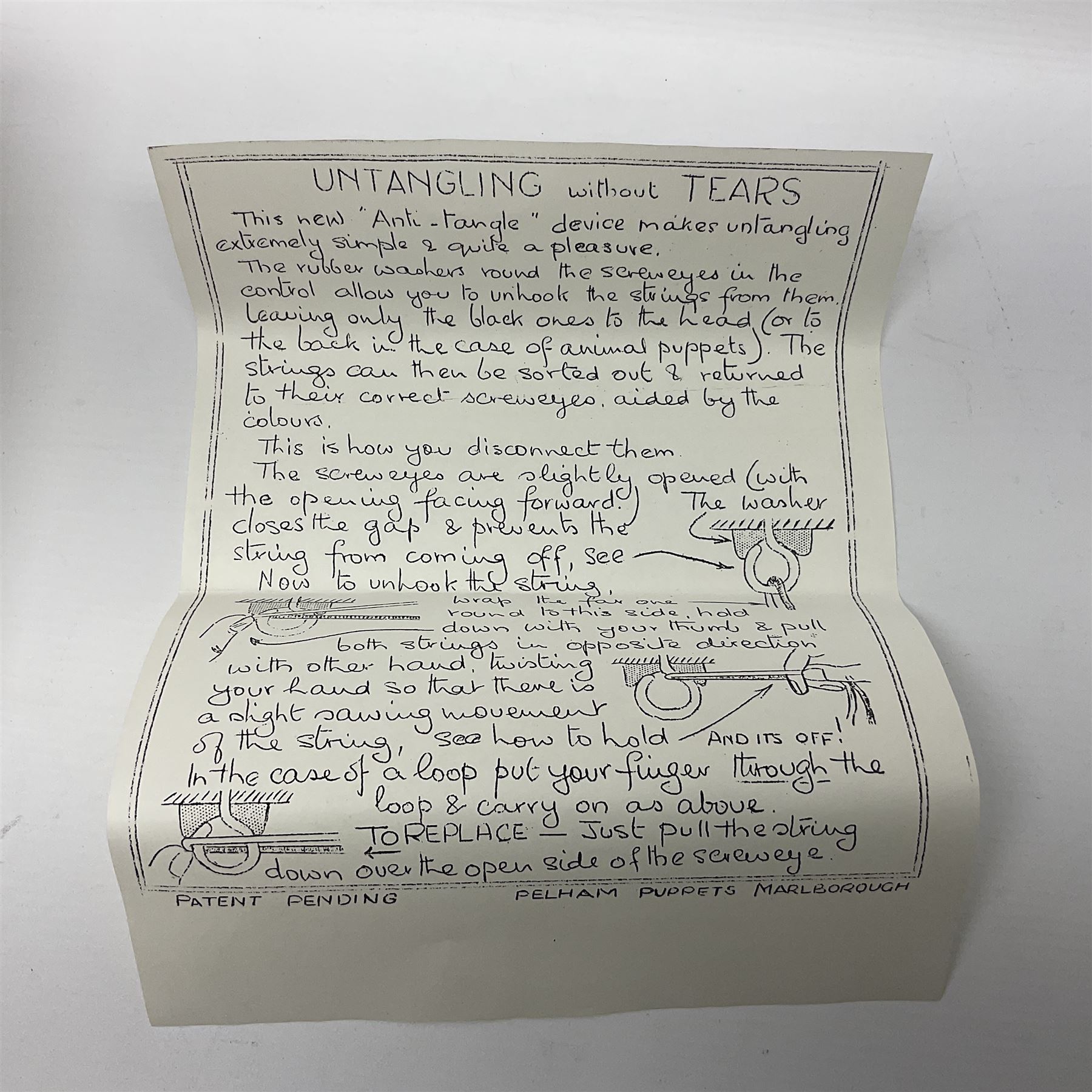 Pelham Puppet - a rare type SM Harlequin circa 1950s with painted black face mask, black felt hat, green ruff and red white chequered suit, H31cm; in original box with instructions 