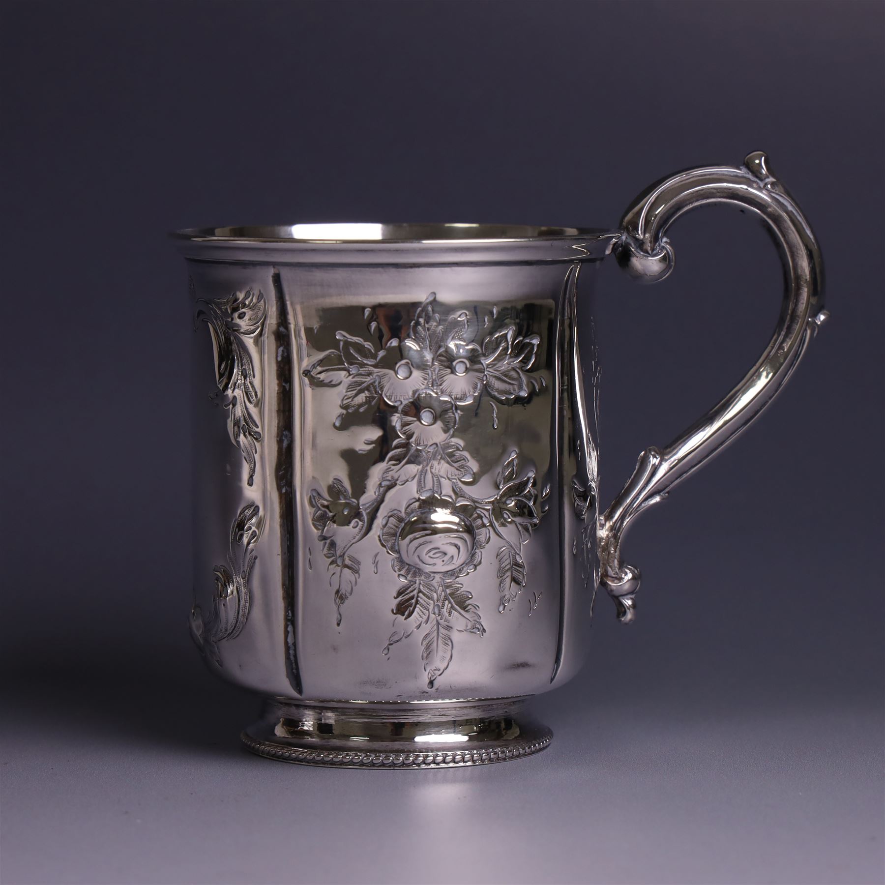 Victorian silver christerning mug, of cylindrical form with four panels of embossed floral decoration, hallmarked H J Lias & Son, London 1876, H10cm