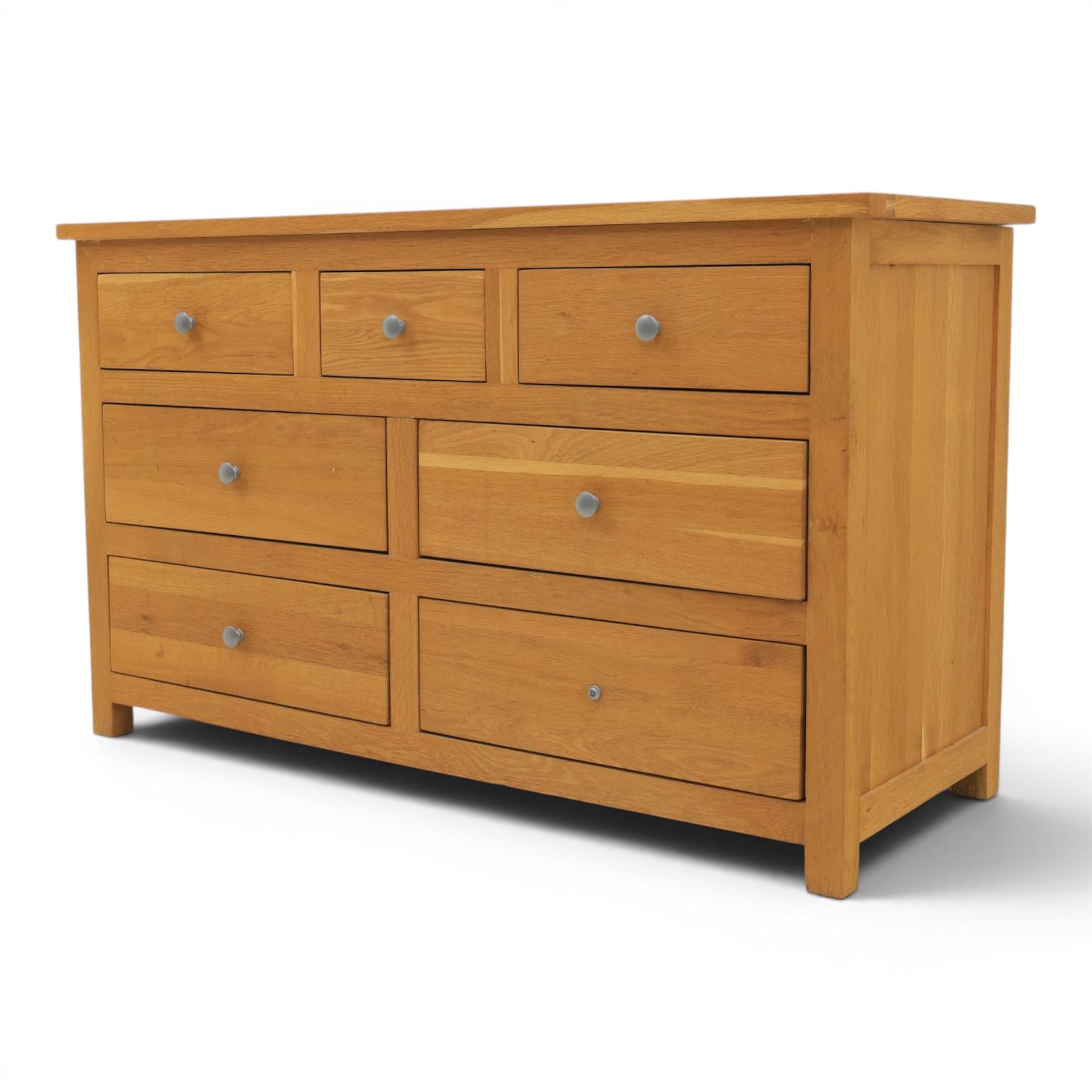 Solid oak chest of drawers, three over four drawers with metal pulls 
