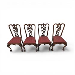 Chippendale design set of ten (8+2) mahogany dining chairs, serpentine cresting rails with carved detail over pierced ribbon-tied splats, red damask upholstered drop-in seats, on cabriole supports with acanthus carved knees and claw and ball feet