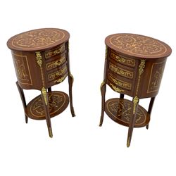 Pair of French design inlaid mahogany bedside lamp tables, oval form and fitted with three drawers, inlaid throughout with scrolling leafy branches, on cabriole supports united by undertier, decorated with floral cast gilt metal mounts 