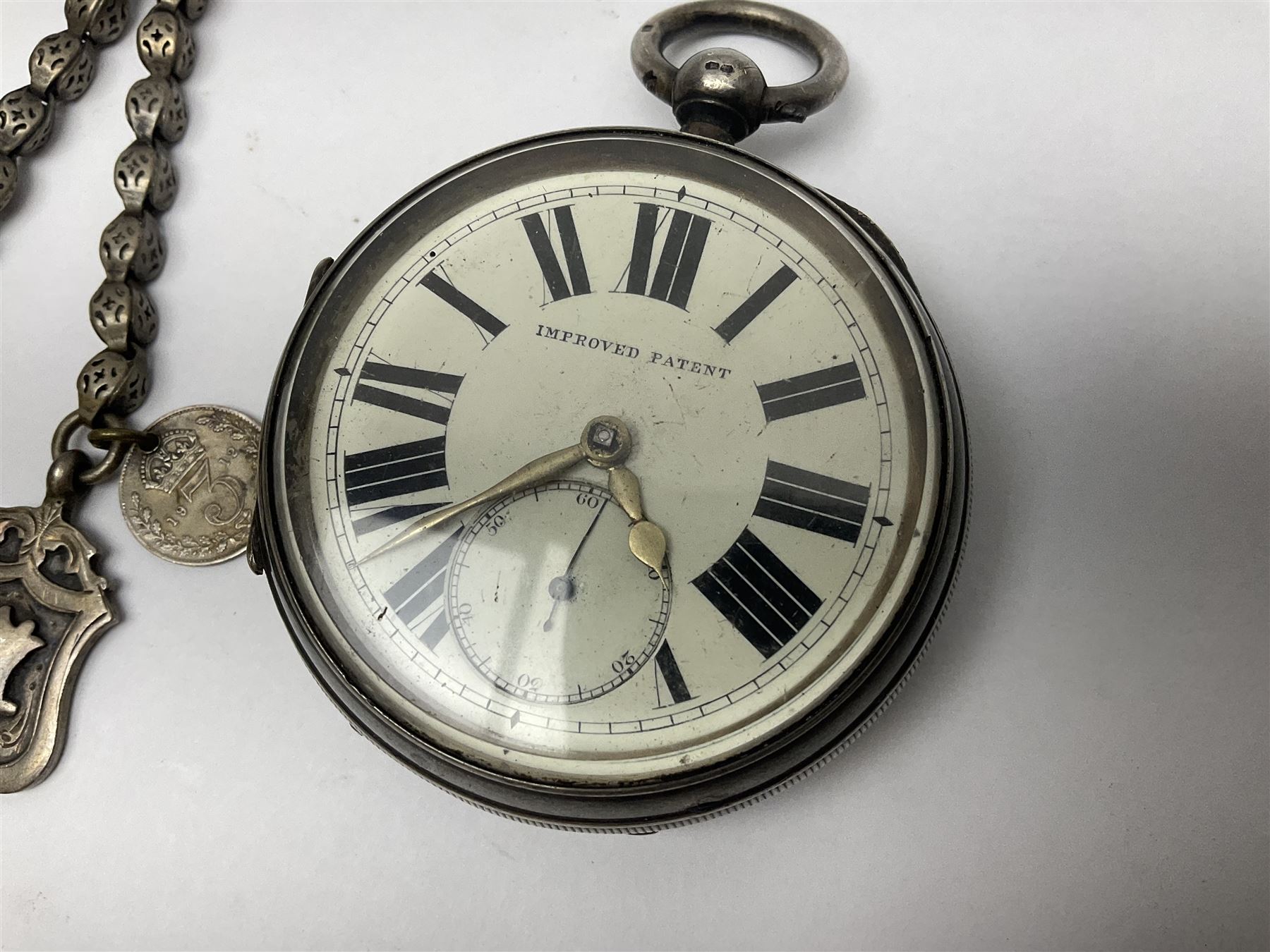 Victorian silver open face fusee lever pocket watch by D A Olswang, Sunderland, No. 7904, white enamel dial with Roman numerals and subsidiary seconds dial, case hallmarked Chester 1895 and a watch chain with silver fob and coin

 

