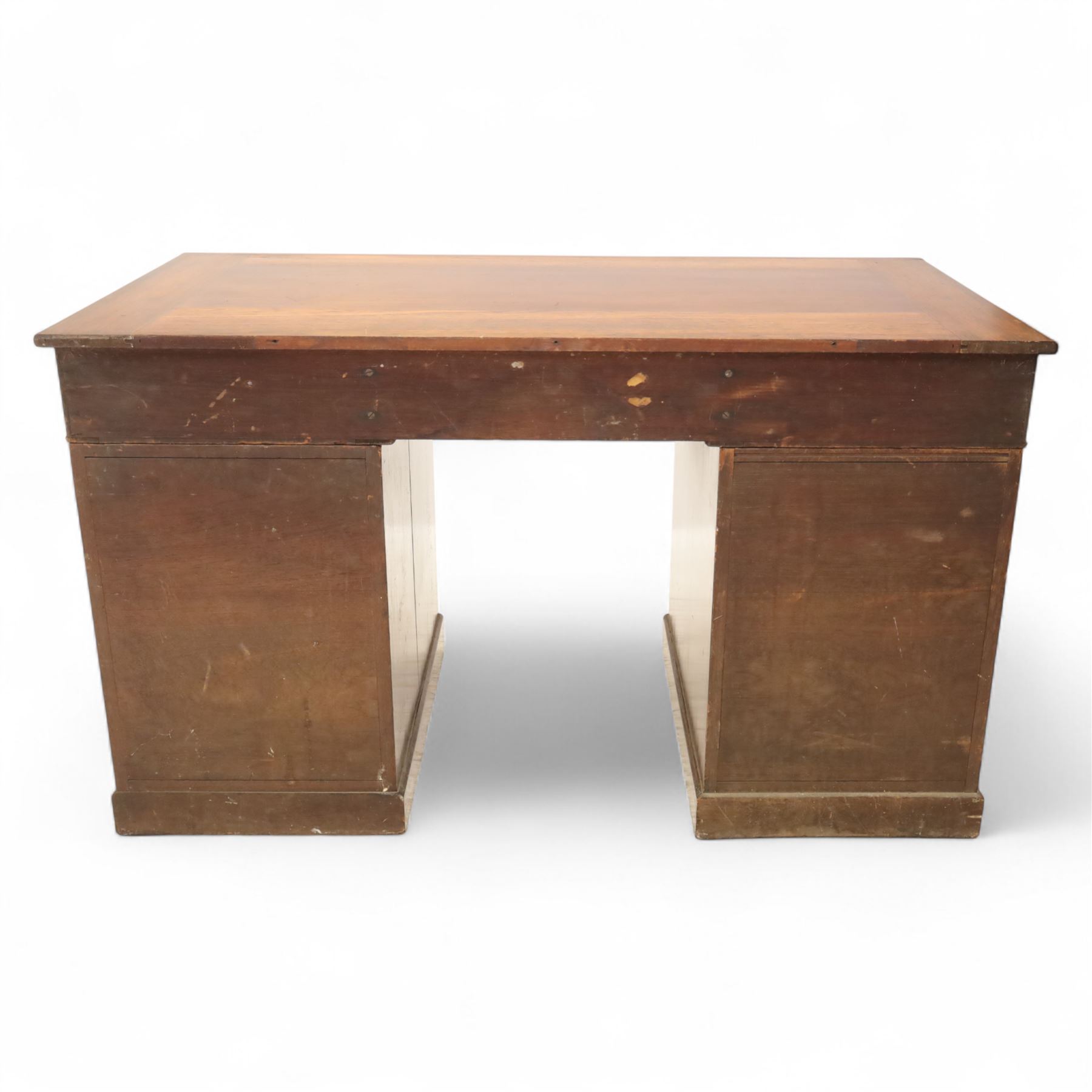 Early 20th century Indian hardwood pedestal desk, rectangular top with moulded edge over three frieze drawers, twin pedestals each fitted with four drawers, brass pierced swing handles and brass escutcheons, upon plinth bases  