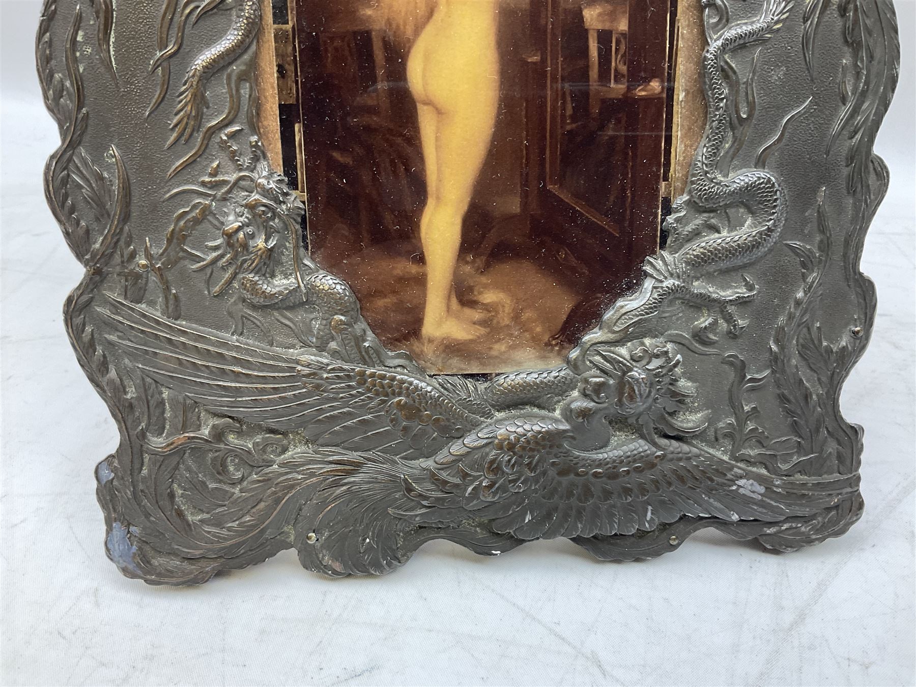 Japanese bronzed antimony frame, decorated with dragons and ho ho birds, easel stand to reverse, containing Continental crystoleum of female nude, H24cm