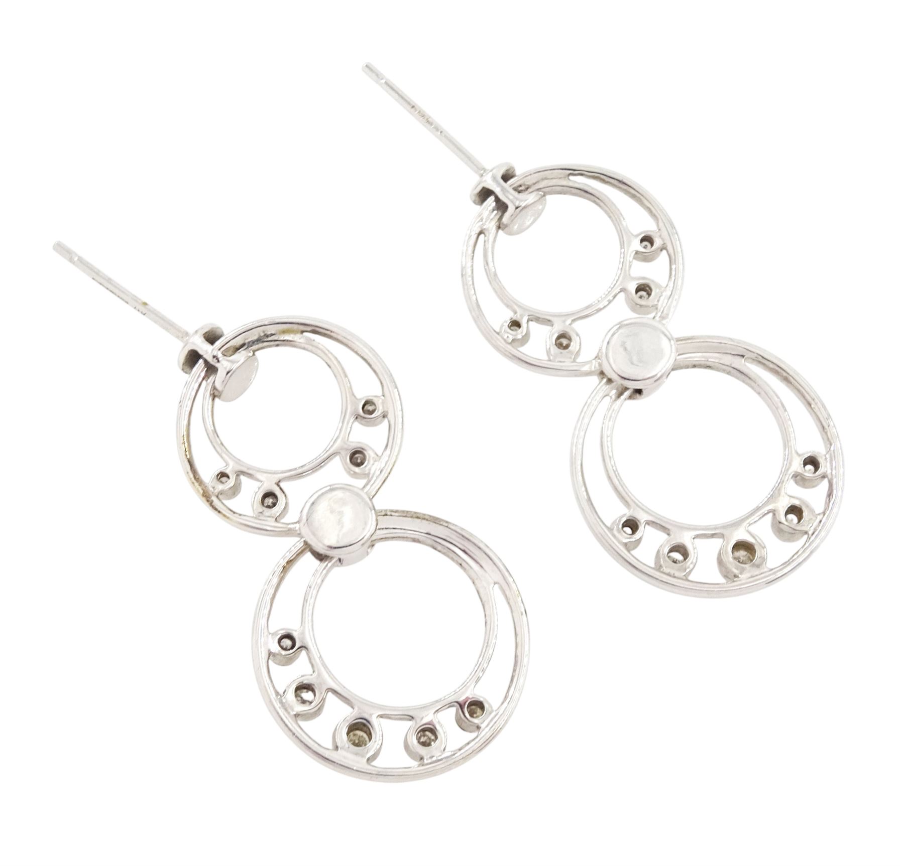 Pair of 9ct white gold diamond pendant earrings, each stud with two circular drops, set with nine round brilliant cut diamonds