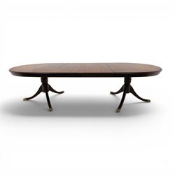 Regency design mahogany extending twin pedestal dining table with two additional leaves, raised on splayed supports terminating brass paw feet
Extends to 268cm