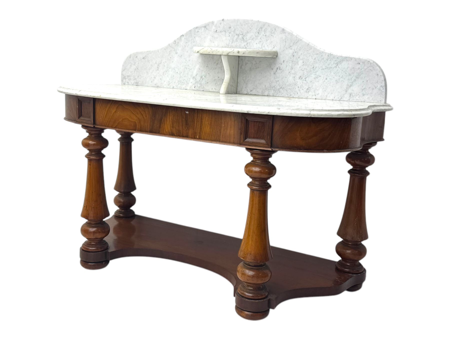 Mid-19th century mahogany washstand, the serpentine white marble top with raised gallery back and central shelf above a frieze drawer, supported by turned columns united by a shaped undertier, raised on bun feet