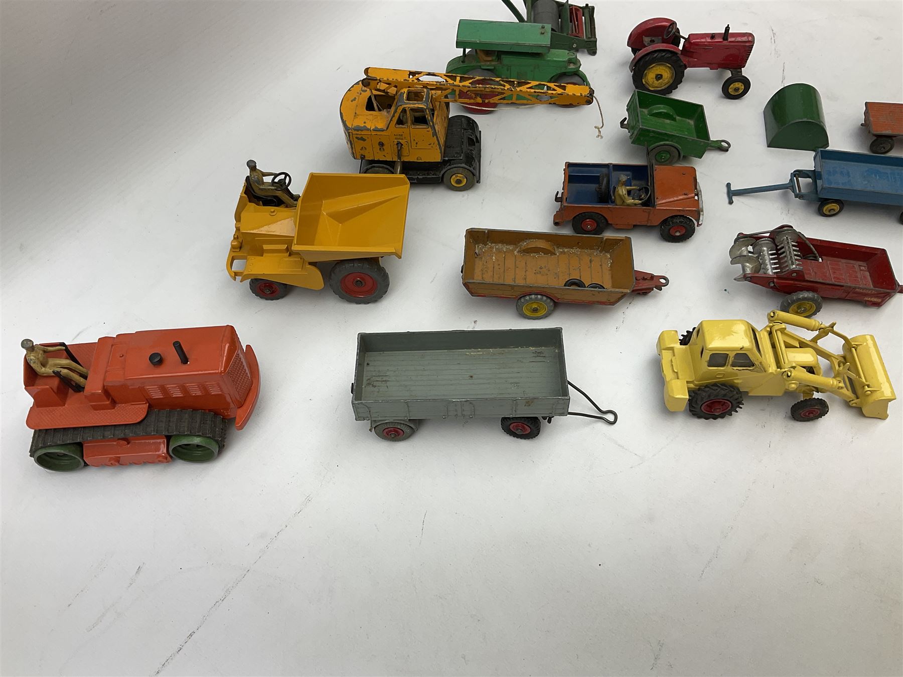 Dinky - nineteen unboxed and playworn/repainted die-cast models including Muir Hill Dumper, Muir Hill 2WL and Heavy Tractor; all repainted; Coles Mobile Crane, two Aveling-Barford steam rollers; Massey-Harris tractor and manure spreader; Land Rover; nine various trailers etc (19)