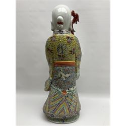 Chinese Republic Period porcelain figure, modelled as Shoulao, wearing elaborately enamelled robes decorated with peaches and flower heads, with impressed mark beneath, H55cm