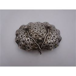 Middle Eastern silver bon bon dish, of oval form, with lobed rim and twisted loop handle, with repousse and chased floral and foliate decoration throughout, upon three bun feet
