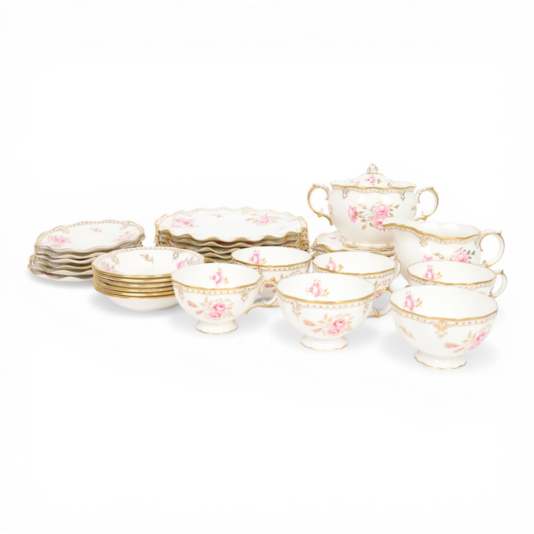 Modern Royal Crown Derby tea set for six place settings, decorated in the Royal Pinxton Roses pattern, comprising tea cups, saucers, small dishes, side plates, dessert plates, one serving plate, twin handled lidded sucrier and milk jug