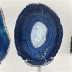 Pair of blue agate slices, polished with rough edges, raised upon silvered metal stands, H26cm