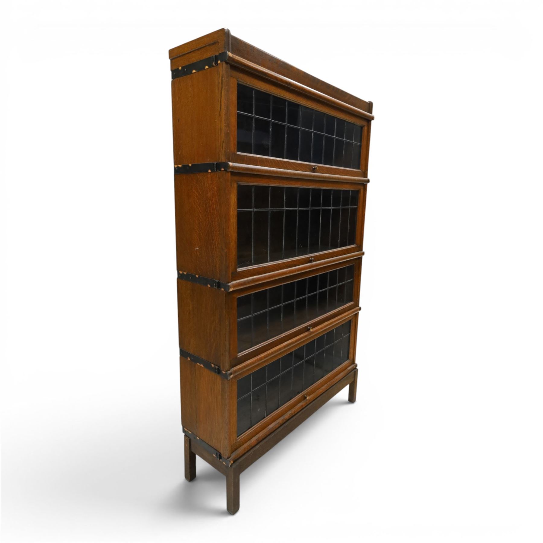 Globe Wernicke - oak four tier barrister bookcase, with leaded glazed fronts, raised on square supports