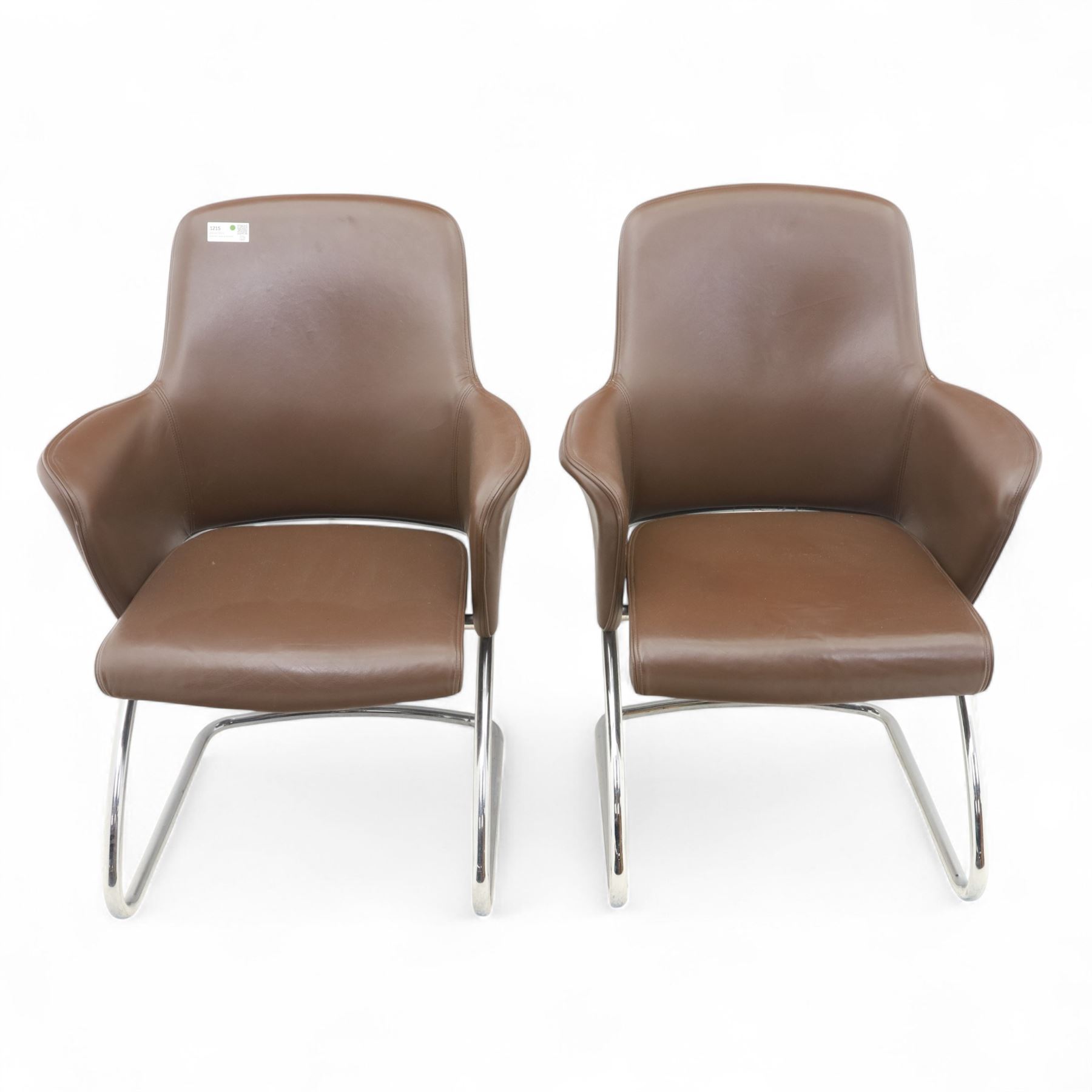Two Senator executive cantilever chairs, upholstered in Padova hide, moulded back and integrated armrests, raised on a tubular chromed cantilever base