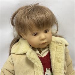 Two Zapf Creation limited edition designer collection dolls, by Brigette Paetsch, the first example with faux suede jacket, red jumper and denim skirt, no. 460, the second example 'Linda' in white dress with teddy bear accessory, no. 785, each signed B Paetsch, tallest L60cm