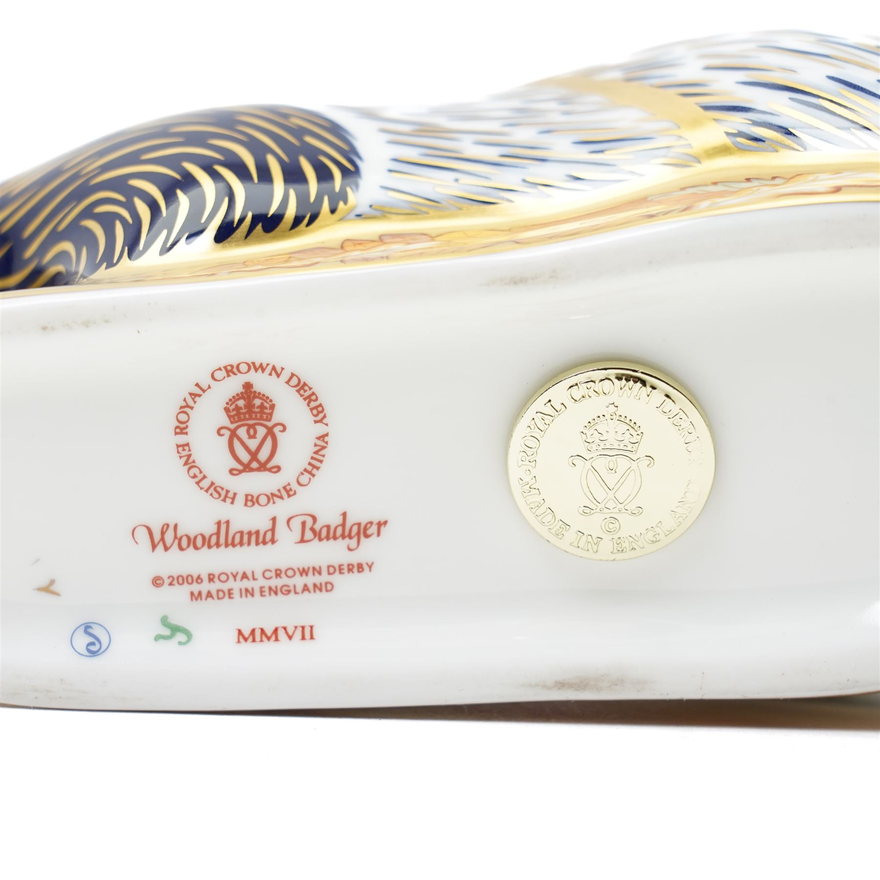 Three Royal Crown Derby paperweights, comprising two of Bramble the Hedgehog, with gold stopper, with boxes, and one of a Woodland Badger, with gold stopper, boxed (3)