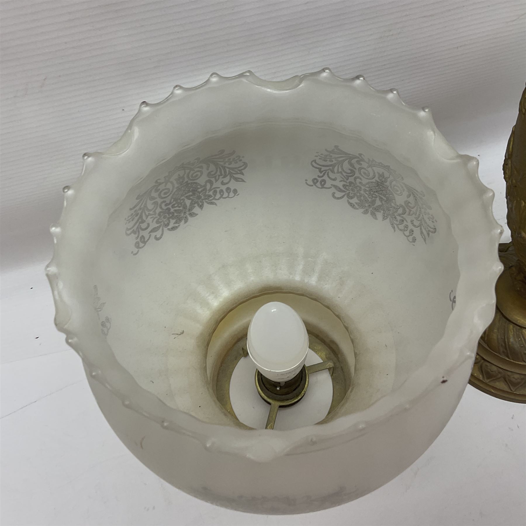 Gilt metal table lamp, heavily embossed with flowers and butterflies, with fluted frosted glass shade, H56cm