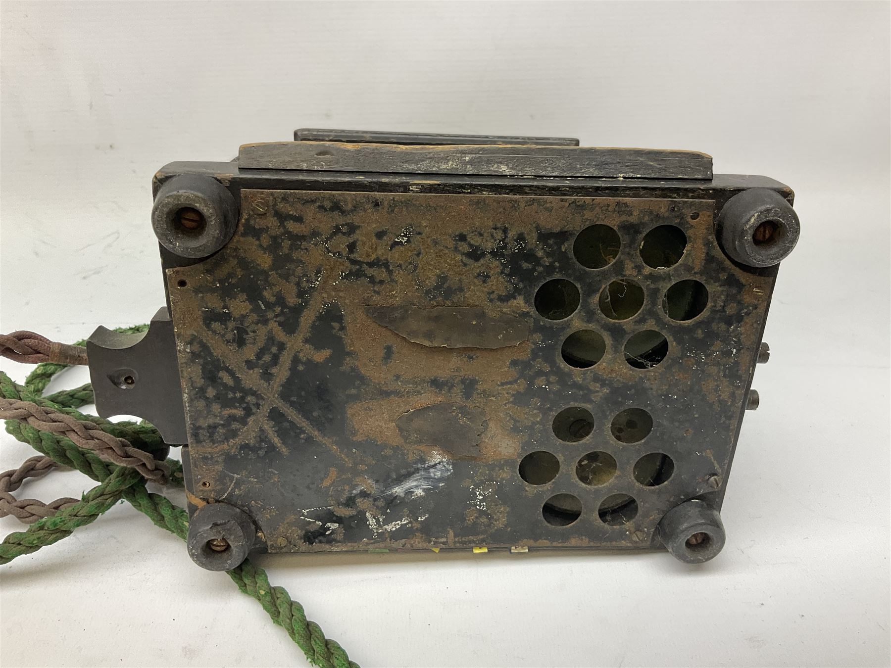 Early 20th century Danish desk telephone inscribed The Ericsson Bell Telephone Co. Glasgow to one side and Aktieselskabet Electrisk Bureau Kristiansand to the other, ebonised wooden top with handset on brass cradle. black japanned tin centre section bearing Hull Corporation Telephones Department crest, side cranking handle and ebonised wooden base H30cm  