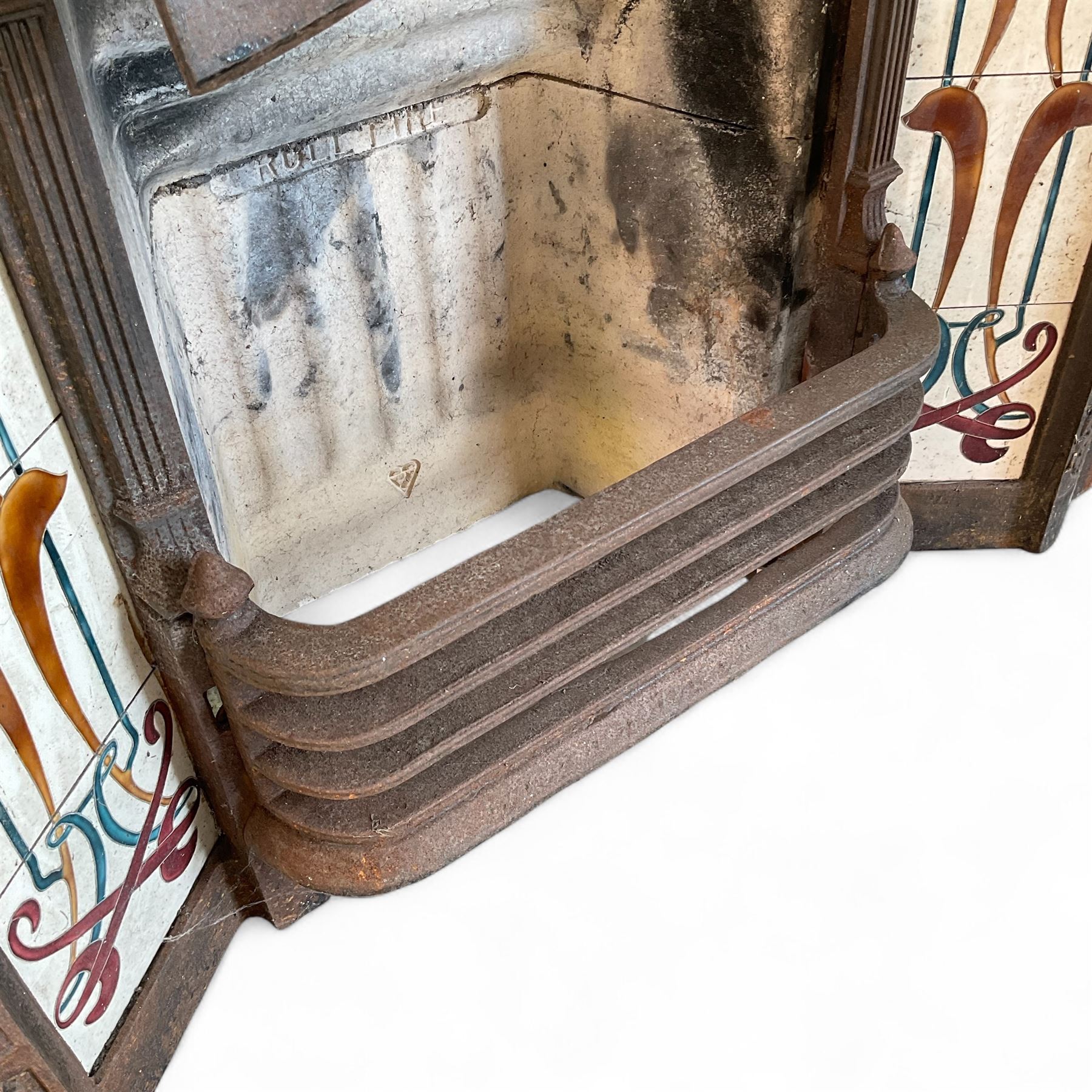 Art Nouveau Cast Iron Fire Surround and fire brick, with floral design tiles inlayed,